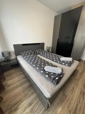 a large bed with stars on it in a bedroom at Metropolitan Paradise & private parking in Sofia