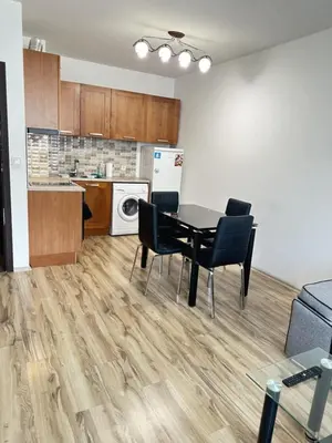 a kitchen and dining room with a table and chairs at Metropolitan Paradise & private parking in Sofia