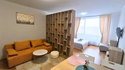 a living room with a couch and a bedroom at Cozy SPA Retreat with free Bottle of Wine in Aspen Golf in Razlog