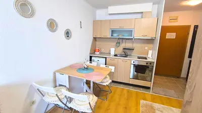 a small kitchen with a small table and chairs at Cozy SPA Retreat with free Bottle of Wine in Aspen Golf in Razlog