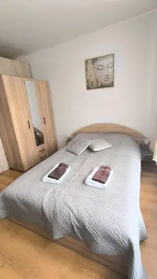 a bedroom with a bed with two pictures on it at Cozy SPA Retreat with free Bottle of Wine in Aspen Golf in Razlog