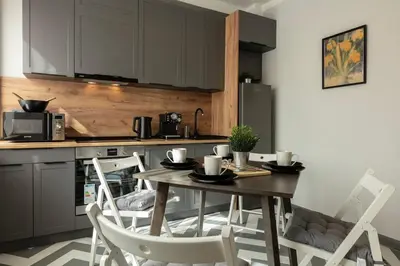 a kitchen with a table and chairs in a kitchen at Downtown Stylish Flat in Sofia