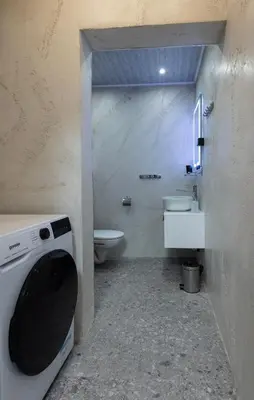 a bathroom with a toilet and a washing machine at Downtown Stylish Flat in Sofia