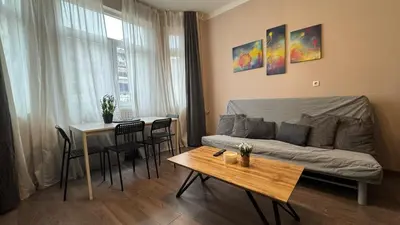 a living room with a bed and a table at Superb 2 Bedroom Top Central Apartment in Sofia