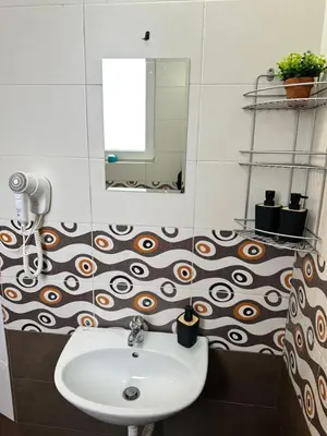 a bathroom with a sink and a mirror at Superb 2 Bedroom Top Central Apartment in Sofia