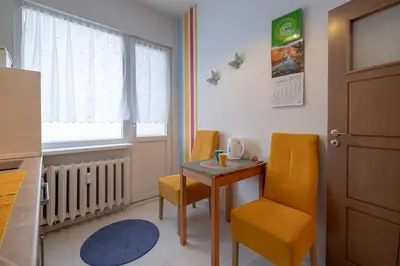a small table and chairs in a room with a window at Little HoMe with a Park View by Flat Mаnager in Sofia