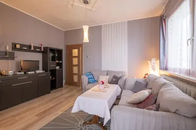 a living room with a couch and a table at Little HoMe with a Park View by Flat Mаnager in Sofia