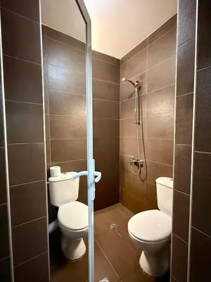 a bathroom with two toilets and a shower at Maxi studio & private parking included in Sofia