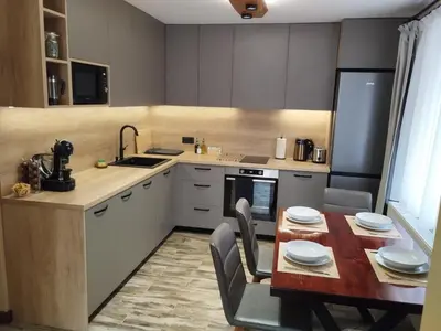 a kitchen with a table and a dining room at ADVENTURE apartments Trigrad in Trigrad