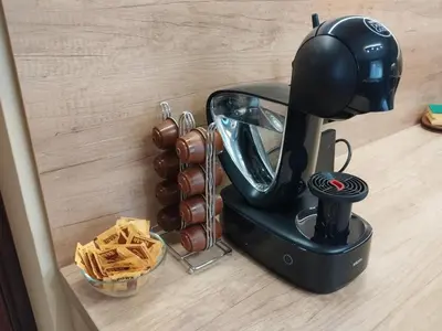 a coffee maker on a counter next to a bowl of chips at ADVENTURE apartments Trigrad in Trigrad