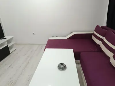 a living room with a purple couch and a table at One-Bedroom Apartment-14 Filip Makedonski 49B in Plovdiv