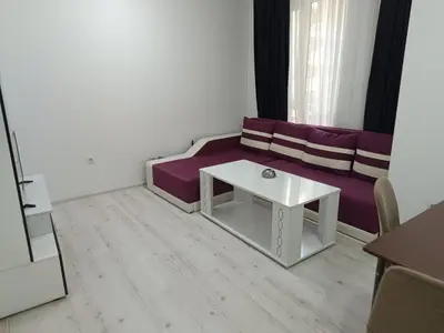 a living room with a purple couch and a table at One-Bedroom Apartment-14 Filip Makedonski 49B in Plovdiv