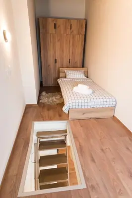 a small room with a bed and a closet at Artistic and cozy apartment in the center of Sofia in Sofia