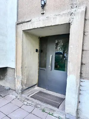 an open door of a building with a door mat at Artistic and cozy apartment in the center of Sofia in Sofia