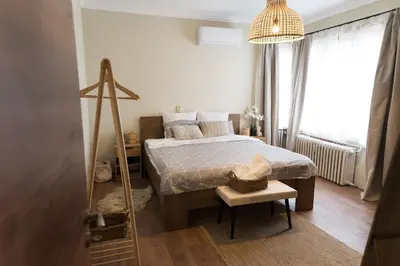 a small bedroom with a bed and a window at Artistic and cozy apartment in the center of Sofia in Sofia