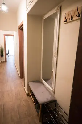 a dressing room with a bench in front of a mirror at Artistic and cozy apartment in the center of Sofia in Sofia