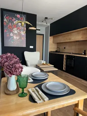 a dining room table with plates and flowers on it at Studio79 in Plovdiv