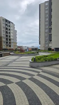 a tiled courtyard in a city with tall buildings at Studio79 in Plovdiv