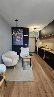 a living room with a white couch and a table at Studio79 in Plovdiv
