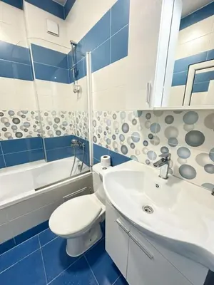 a blue and white bathroom with a toilet and a sink at Paradise Comfort in Sofia