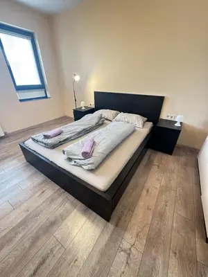 two beds in a bedroom with wooden floors at Paradise Comfort in Sofia
