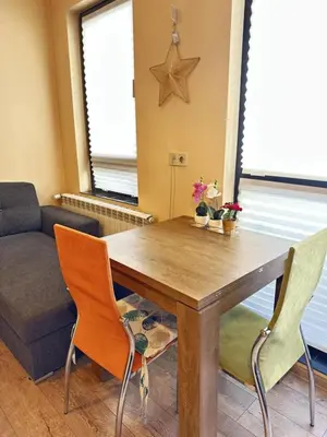 a dining room table with two chairs and a couch at Paradise Comfort in Sofia