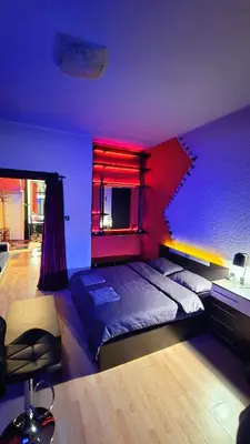 a bedroom with a large bed with a red ceiling at Sofia's Gem Apartment - Prime Location in Sofia
