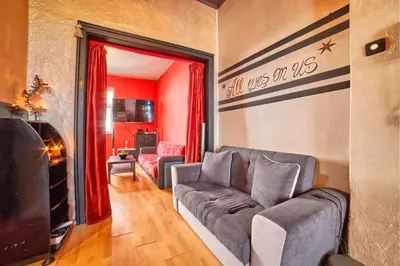 a living room with a couch and a tv at Sofia's Gem Apartment - Prime Location in Sofia