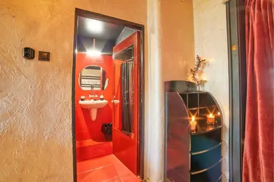 a bathroom with a sink and a red wall at Sofia's Gem Apartment - Prime Location in Sofia