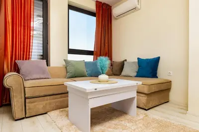 a living room with a couch and a table at City Park flat near to Medical University in Plovdiv