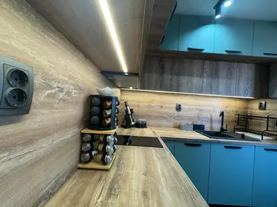 a kitchen with blue cabinets and a counter top at Kamberovi house Kalofer in Kalofer