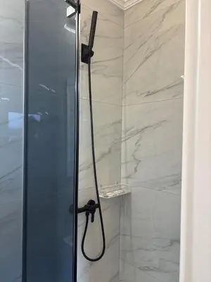 a shower with a glass door in a bathroom at Kolev Apartment 1 in Sofia