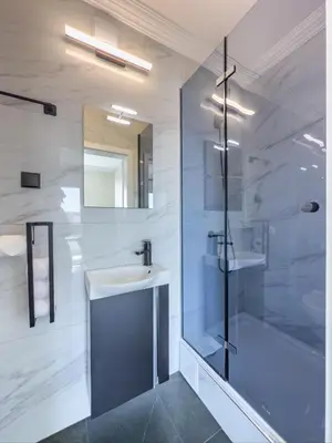 a bathroom with a shower and a sink and a tub at Kolev Apartment 1 in Sofia