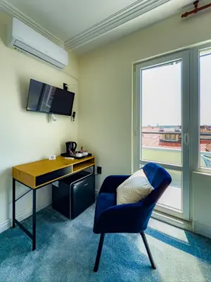 a room with a desk and a blue chair at Kolev Apartment 1 in Sofia