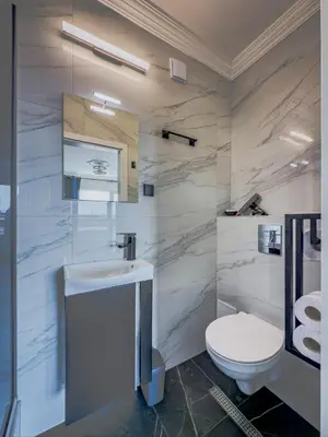 a bathroom with a white sink and a toilet at Kolev Apartment 2 in Sofia