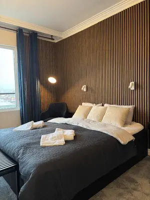 a bedroom with a large bed with two towels on it at Kolev Apartment 2 in Sofia