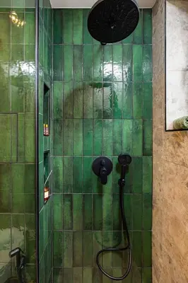 a green tiled shower with a shower head at 2 BR Apt Dzhendem Tepe 2 Parking Spots in Plovdiv next to MU in Plovdiv
