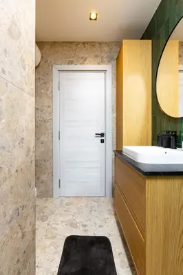 a bathroom with a sink and a white door at 2 BR Apt Dzhendem Tepe 2 Parking Spots in Plovdiv next to MU in Plovdiv