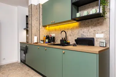 a kitchen with green cabinets and a sink at 2 BR Apt Dzhendem Tepe 2 Parking Spots in Plovdiv next to MU in Plovdiv