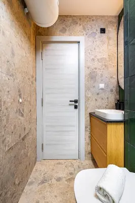a bathroom with a white door and a sink at 2 BR Apt Dzhendem Tepe 2 Parking Spots in Plovdiv next to MU in Plovdiv