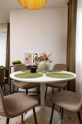 a dining room table with chairs and a vase on it at 2 BR Apt Dzhendem Tepe 2 Parking Spots in Plovdiv next to MU in Plovdiv