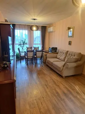 a living room with a couch and a table and chairs at Vitosha Apartment in Sofia