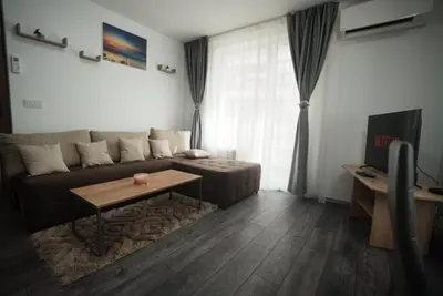 a living room with a couch and a table at Royal nest in Sofia