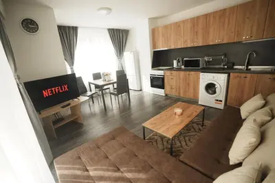 a kitchen and living room with a couch and a table at Royal nest in Sofia