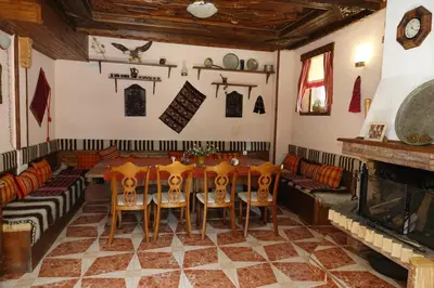 a dining room with a table and chairs and a fireplace at Trigrad hills in Trigrad