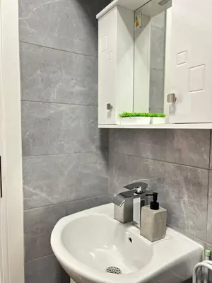 a bathroom with a sink and a mirror at Rea Elita - Fresh and Modern Studio in Sofia