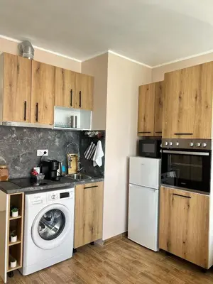 a kitchen with a washing machine and a washer at Rea Elita - Fresh and Modern Studio in Sofia