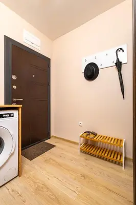 a laundry room with a washing machine and a door at Central Lovely apartment Venu close to Old Town in Plovdiv