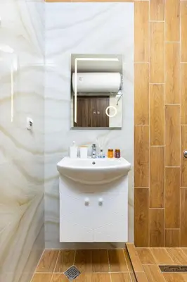 a bathroom with a white sink and a mirror at Central Lovely apartment Venu close to Old Town in Plovdiv