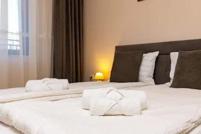 a bedroom with two beds with white towels on them at Central Lovely apartment Venu close to Old Town in Plovdiv
